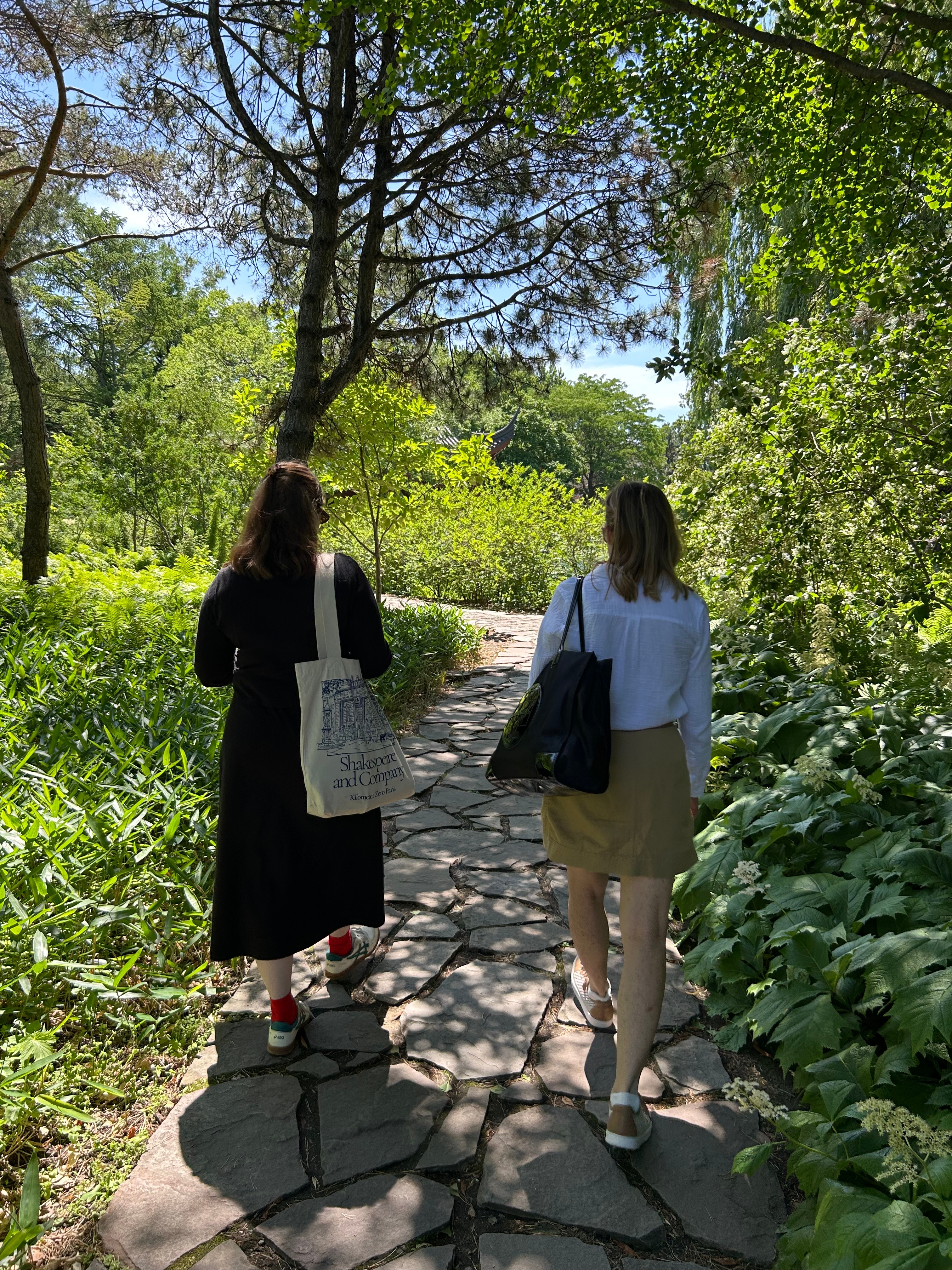 Two adults walking in a garden